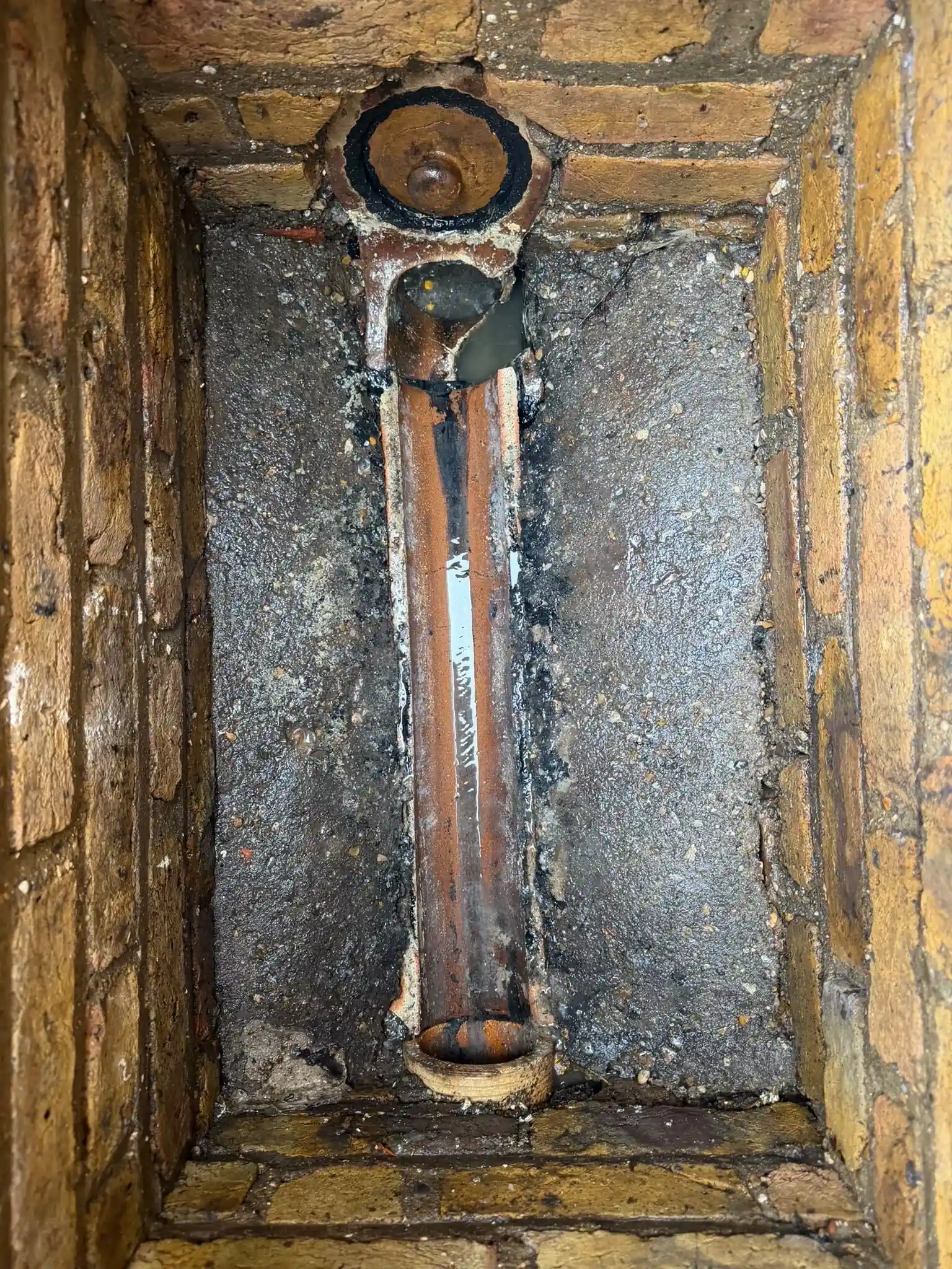 New clay interceptor trap fitted in a clean brick drainage chamber, Berkshire