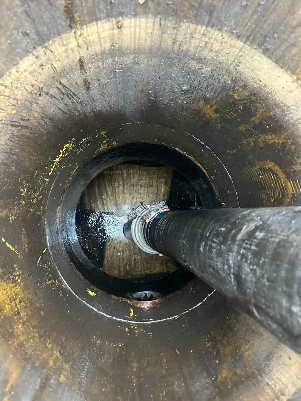 Vacuum hose in a cleaned circular drainage chamber after slow surface drainage was resolved, Berkshire
